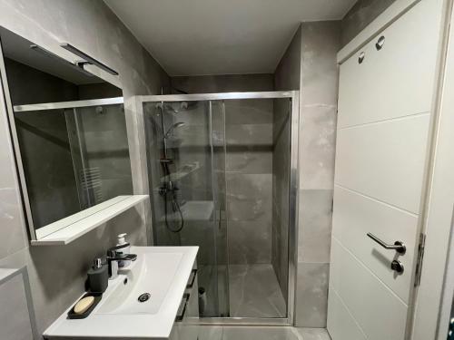 a bathroom with a shower and a sink at Apartman Sara in Zenica