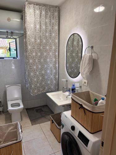a bathroom with a sink and a toilet and a mirror at Relax Pine Villa Residence in Golem