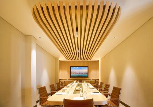 a large conference room with a long table and chairs at Palmyard Hotel in Manama