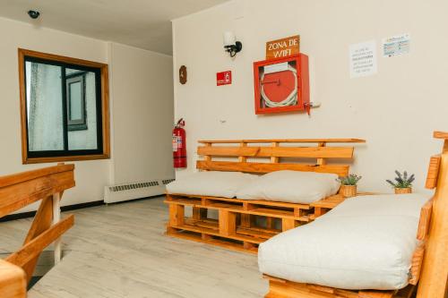 a room with two beds and a window at Hotel Terrazas del Lago in Puerto Varas