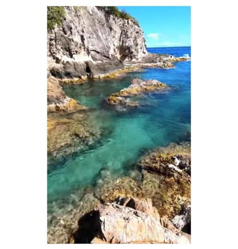 a view of the ocean from a cliff at Cozy Cute Home 2nd floor pay at the property and we have many method of payments just ask us in Fajardo