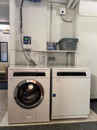 a laundry room with a washer and a dryer at Hotel Adonis in Zermatt