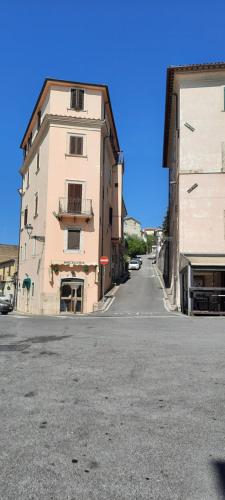 an empty street next to a tall building at Oasi in Poggio Moiano