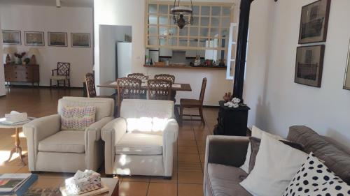 a living room with a couch and chairs and a table at Mediterranean house with beautiful garden in Karlovasi