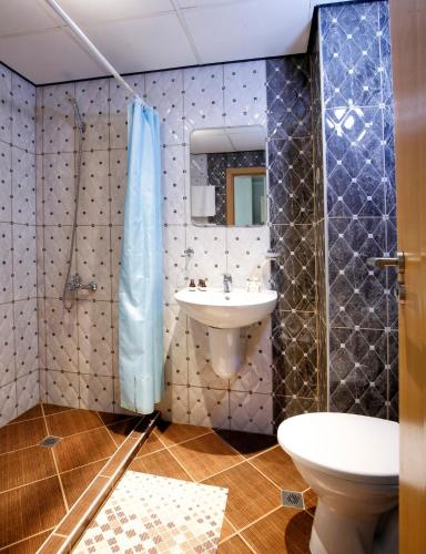 a bathroom with a sink and a toilet at Grand Hotel Nirvana - All Inclusive & Free Beach Access in Sunny Beach