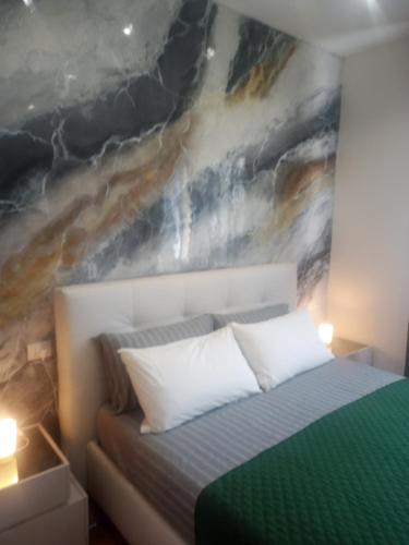 a bedroom with a bed with a painting on the wall at 0541 Guest House Rimini in Rimini