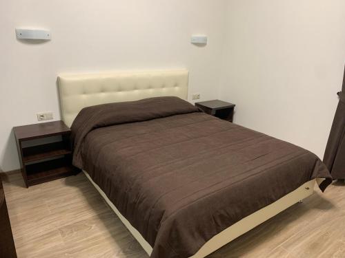a bedroom with a large bed with two night stands at Петрівський in Kropyvnytskyi