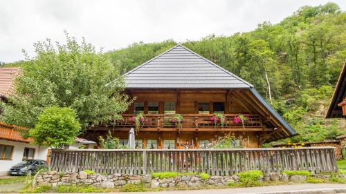 a wooden house with a fence in front of it at Haus Miriam in Münstertal