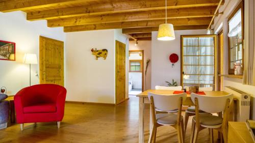 a dining room with a table and red chairs at Haus Miriam in Münstertal