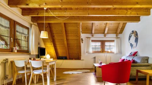a living room with wooden ceilings and a table and chairs at Haus Miriam in Münstertal