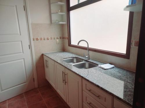 a kitchen with a sink and a window at BaspisDepar in Sucre