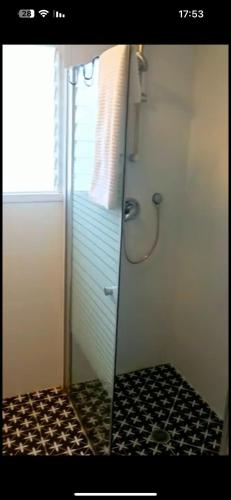 a bathroom with a shower with a glass door at Vacation in the heart of the city netanya in Netanya
