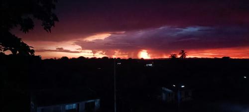 a sunset with a fire in the distance at Apartamento amoblado (Coveñas) in Coveñas