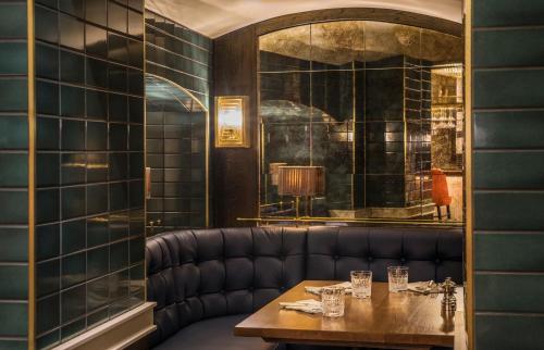 a dining room with a table and a mirror at Sloane Place in London