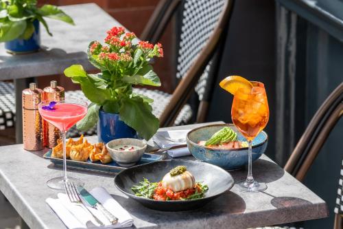 a table with plates of food and drinks on it at Sloane Place in London