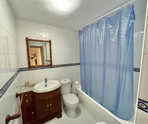a bathroom with a toilet and a sink and a mirror at Doña Julia Golf in Casares