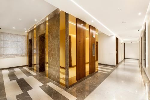 a hallway of a building with yellow and white walls at Narthaki Boutique Hotel in Bengaluru