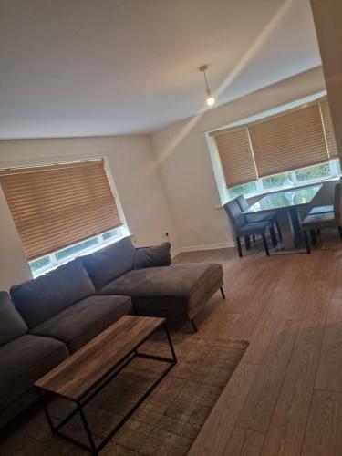 a living room with a couch and two windows at 2 Bed 2 Bath Ensuite - FREE secure parking in Birmingham