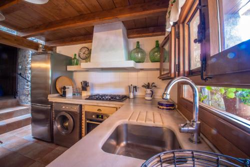 a kitchen with a sink and a stove at Casa Mimosa in Candeleda