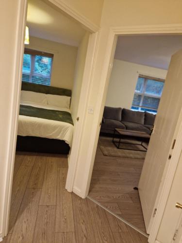 a living room with a bed and a couch at 2 Bed 2 Bath Ensuite - FREE secure parking in Birmingham