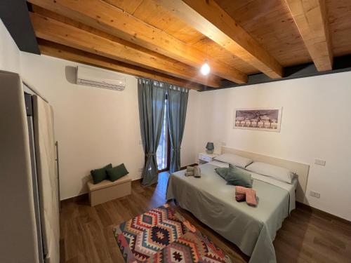 una camera con letto e soffitto in legno di Appartamento Il Poggetto a Montefiascone