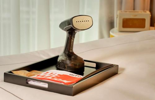 a bottle of beer in a box on a table at art'otel London Battersea Power Station, Powered by Radisson Hotels in London