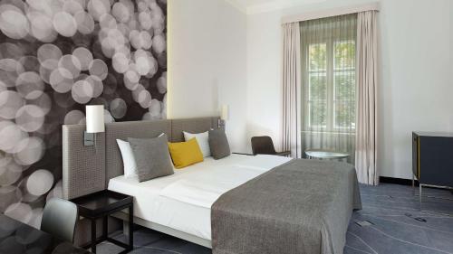 a bedroom with a bed and a wall with balloons at Park Plaza Budapest in Budapest