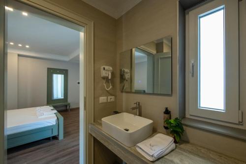 a bathroom with a sink and a mirror at Hotel Vila 11 in Durrës