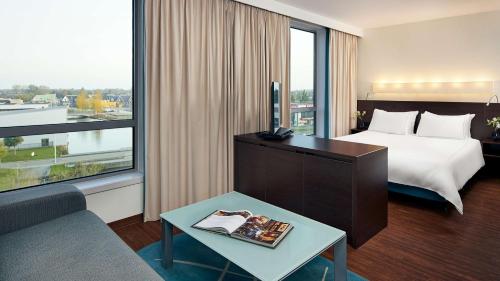 a hotel room with a bed and a large window at Park Plaza Amsterdam Airport in Lijnden