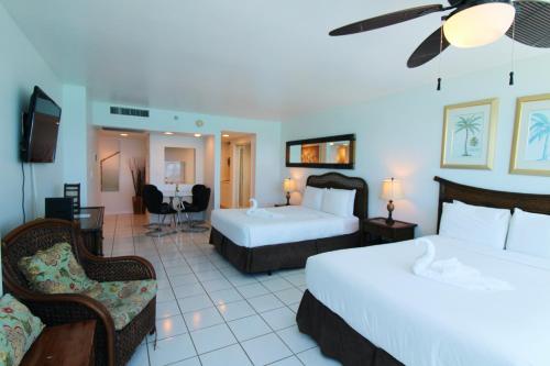 a hotel room with two beds and a tv at Oceanview studio - on beach, gym, bars, and free parking! in Miami Beach