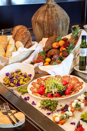 a buffet with many different types of food and bread at Park Plaza Amsterdam Airport in Lijnden
