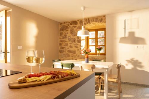 a kitchen with a cutting board with food and wine glasses at BRAND NEW Stone house MARCELA, 3 double bedrooms, pool in Lun