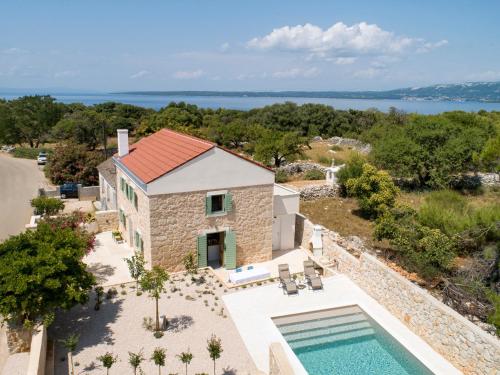 an aerial view of a villa with a swimming pool at BRAND NEW Stone house MARCELA, 3 double bedrooms, pool in Lun