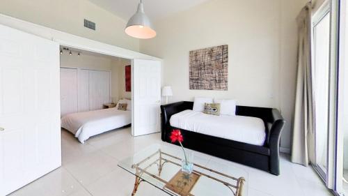 1 dormitorio con 2 camas y mesa de cristal en Gorgeous Oceanfront Penthouse with gym, bars, beach access and free parking!, en Miami Beach