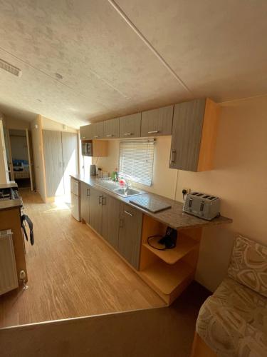 a small kitchen with a sink and a counter top at Fantasy Island, Sunnymede 8 Berth in Ingoldmells