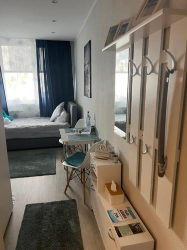 a small room with a bed and a table in it at Business Appartement Mainz in Mainz