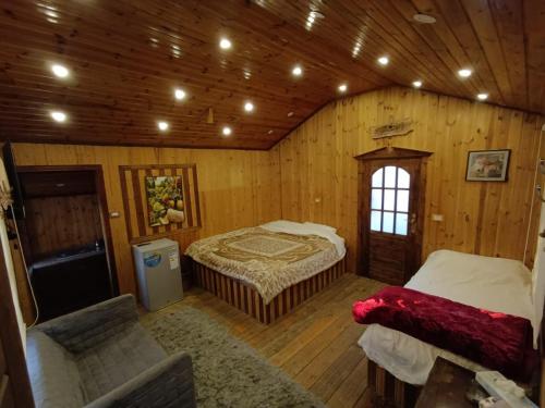 a room with two beds in a wooden cabin at North Jewel 2023 in Ajloun
