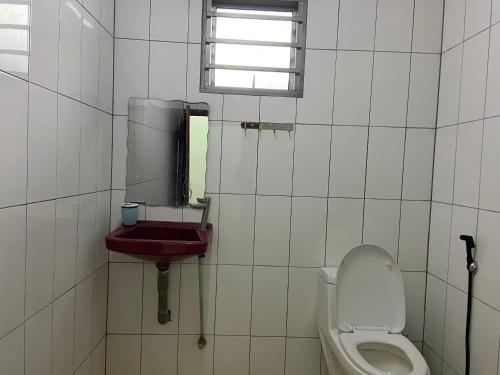 a bathroom with a toilet and a sink at Padang Besar Homestay Firdaus in Padang Besar