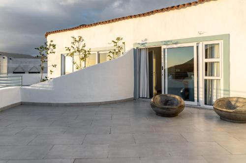 a building with two large bowls on a patio at Capri Sands Luxury Guest House in Capri Village