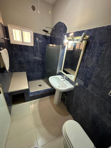 een badkamer met een wastafel, een spiegel en een toilet bij sea View Nautilus free wi-fi Sal Rei in Sal Rei