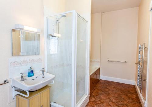 a bathroom with a sink and a shower at Courtney - Upcott House in Barnstaple