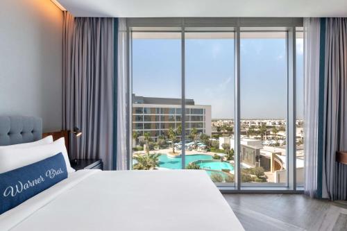 a hotel room with a large bed and a large window at The WB Abu Dhabi, Curio Collection By Hilton in Abu Dhabi