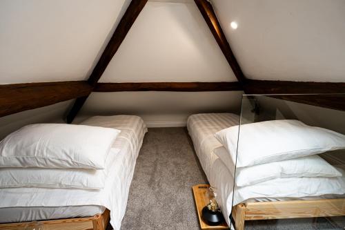 a room with two beds in a attic at Worfe View Cottage 
