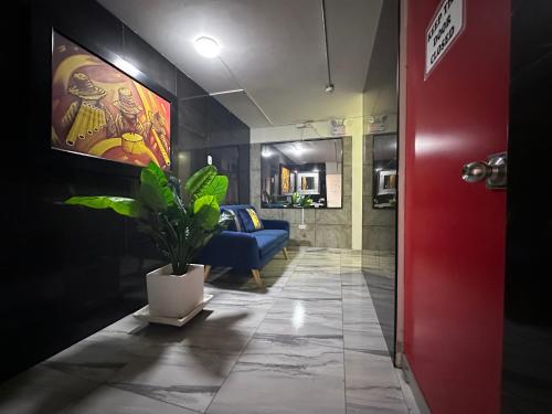a hallway with a blue couch and a potted plant at Ica Adventures II in Ica