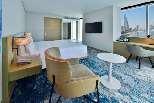 a hotel room with a bed and a desk at Hilton Garden Inn Bahrain Bay in Manama
