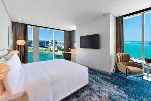 a hotel room with a large bed and a television at Hilton Garden Inn Bahrain Bay in Manama
