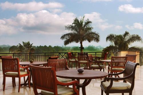 a row of tables and chairs on a patio at Hilton Pyramids Golf in 6th Of October