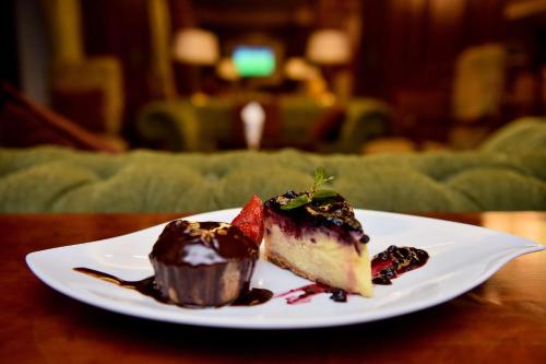a piece of cake on a white plate on a table at Hilton Cairo Zamalek Residences in Cairo