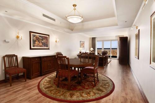 a dining room with a table and chairs at Hilton Cairo Zamalek Residences in Cairo