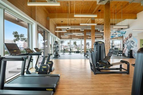 a gym with treadmills and elliptical machines at Fuwairit Kite Beach, Tapestry Collection By Hilton in Fuwayriţ